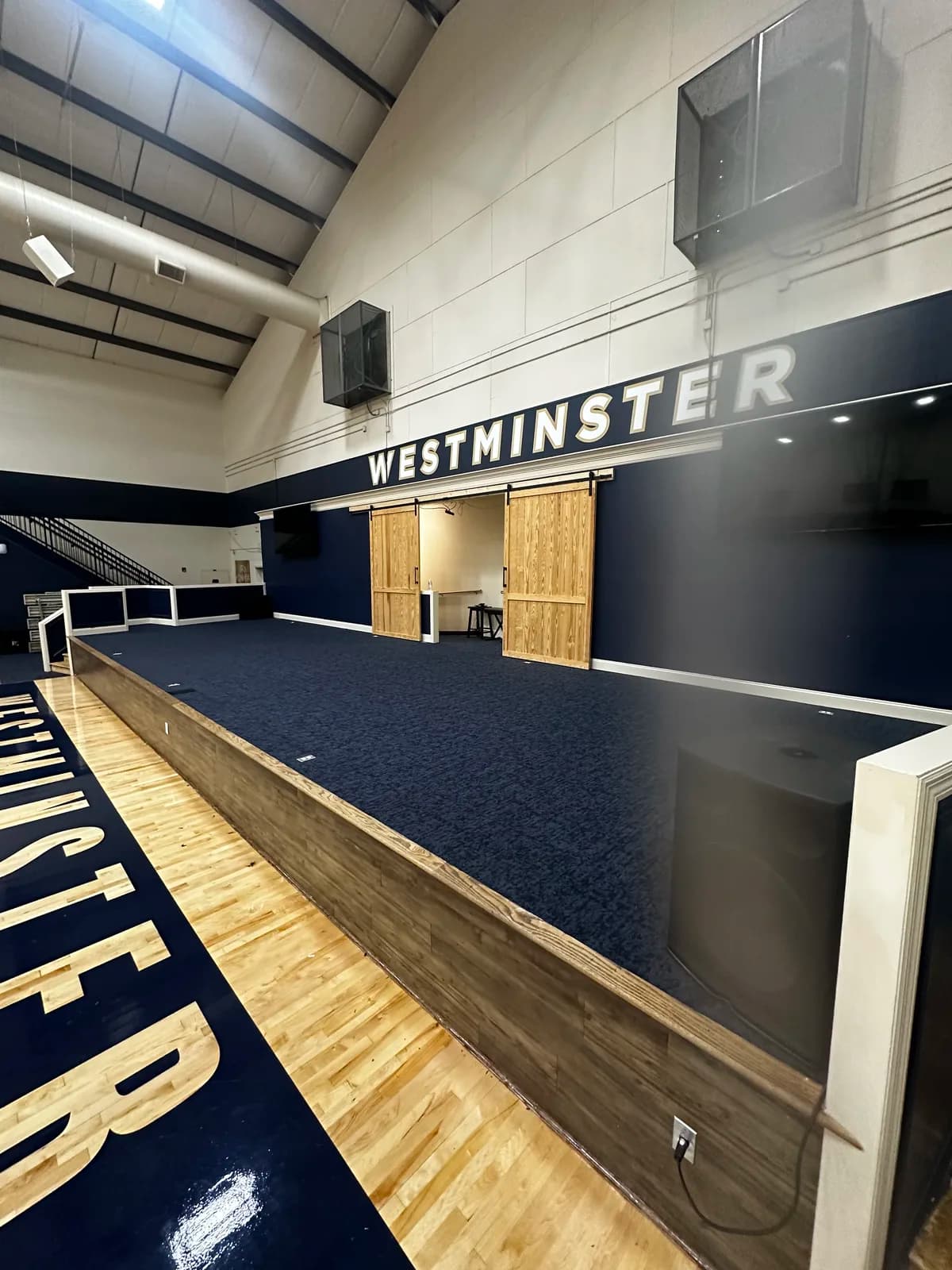 CCT Seaside & Surf Wrightsville carpet tile on a raised gymnasium seating tier at a private school athletics center in Atlanta, Georgia