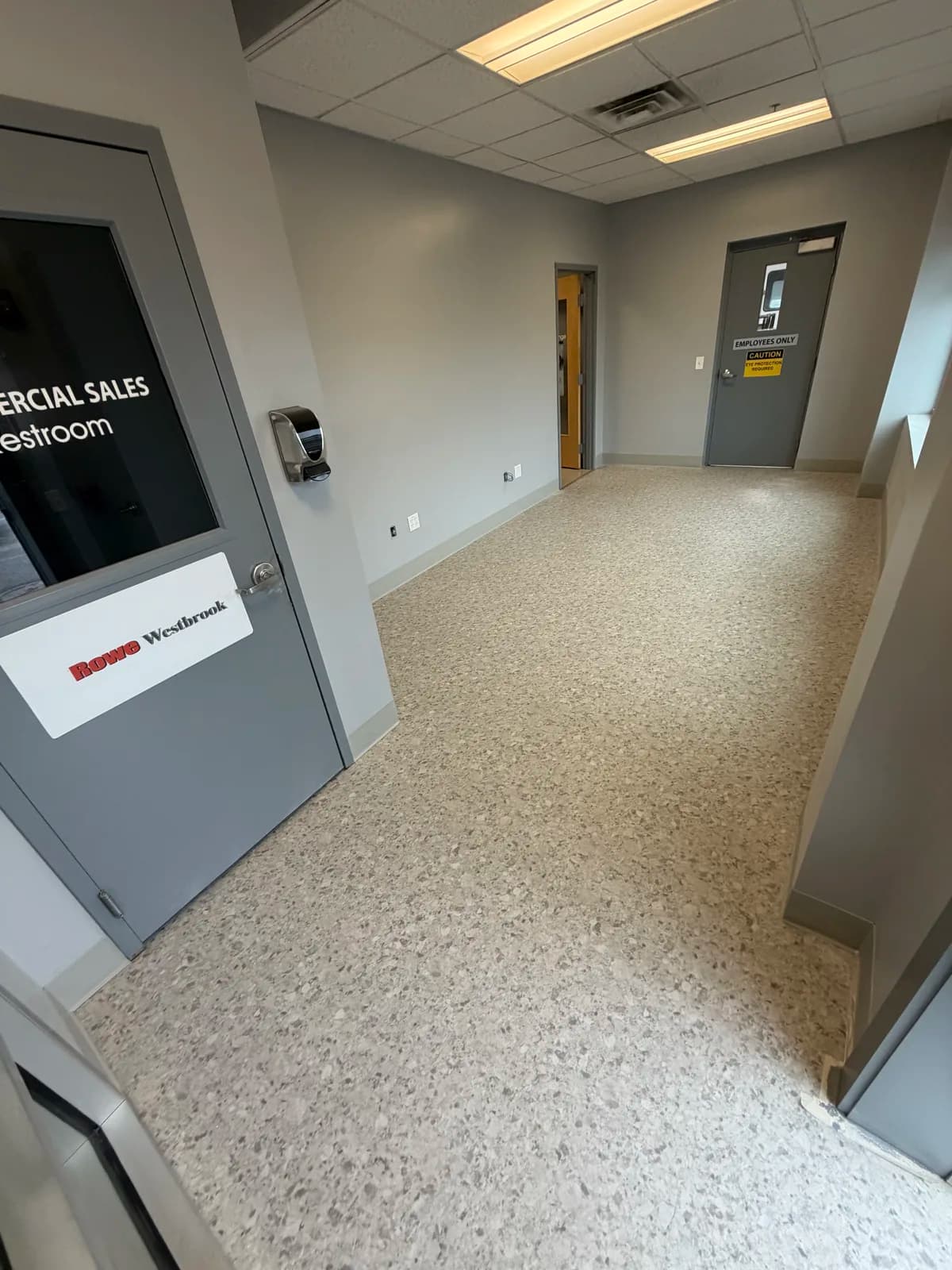 HRQ Riverbed resilient flooring flowing through an auto dealership service corridor in Westbrook, Maine